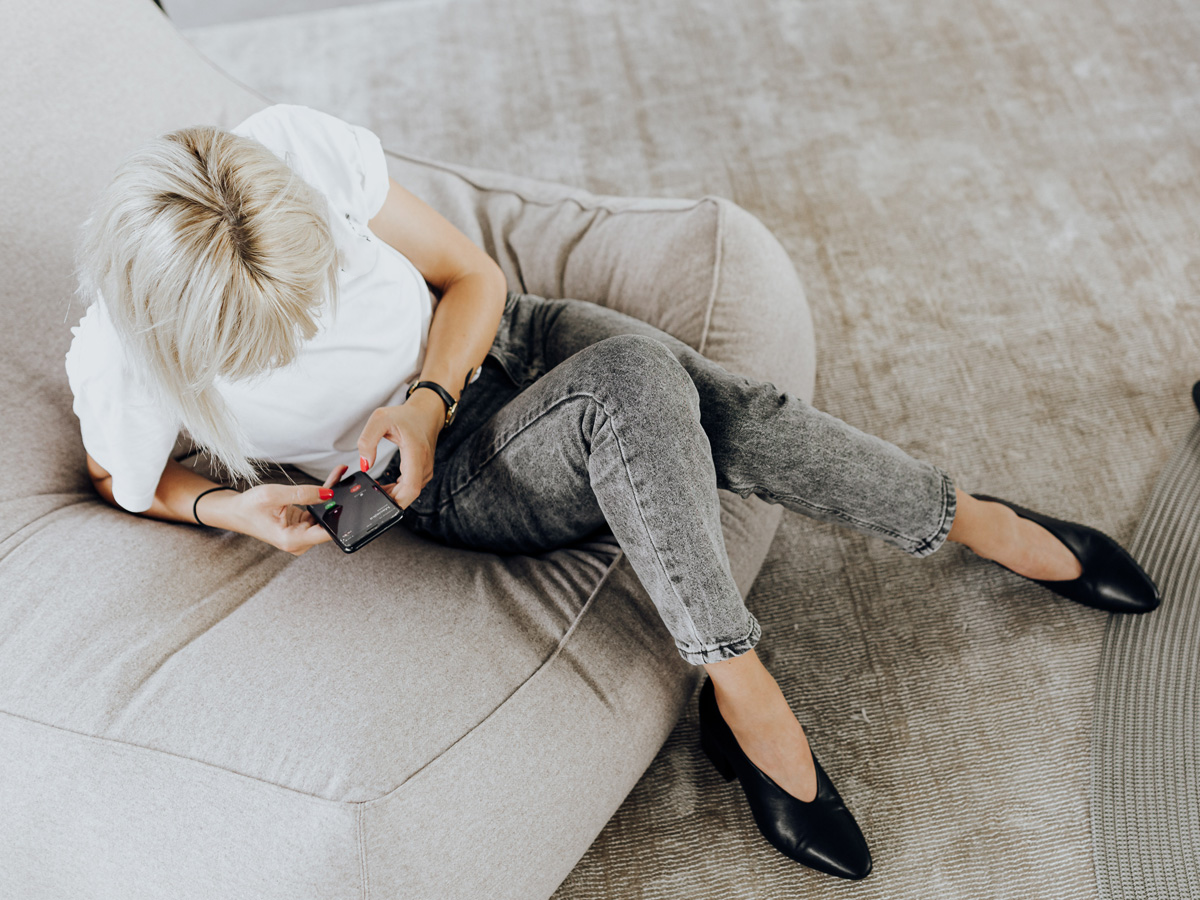 Dame met telefoon belt voor hulp voor haar social media strategie voor ondernemers.